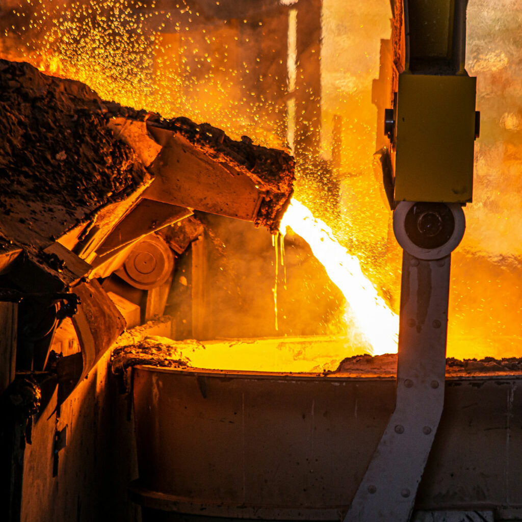 Foundry dust and fumes being generated by molten metal being poured into molds